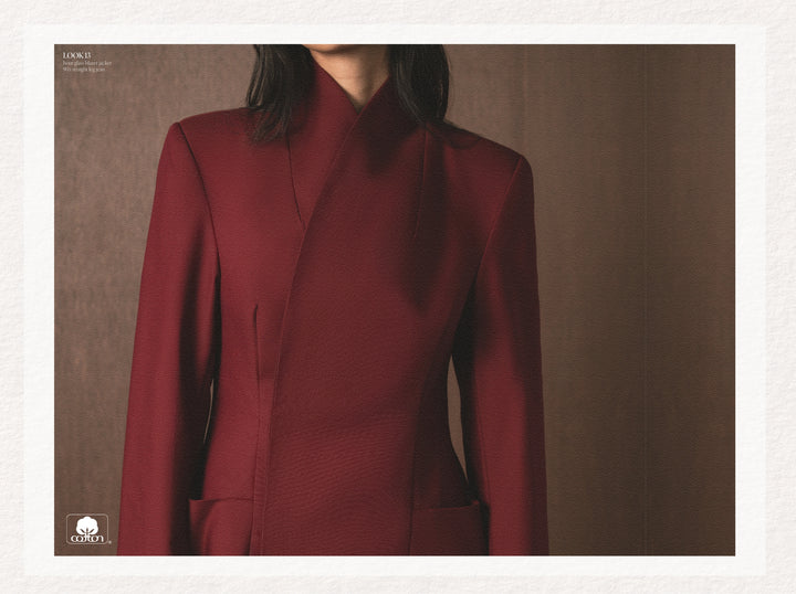 Maroon suit worn by a person against a neutral background