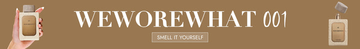 Product packaging with 'WEWOREWHAT 001' branding and a hand holding a small perfume.